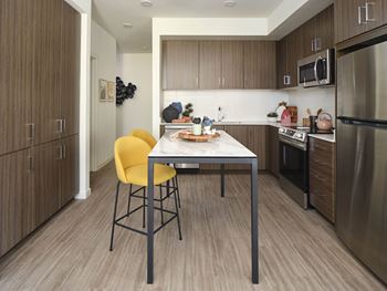 a kitchen with a table and chairs